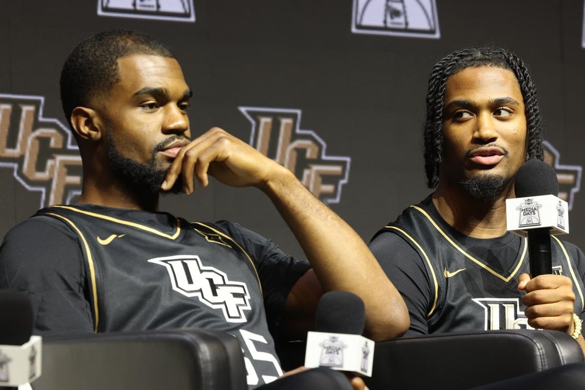 Oct 22, 2025; Kansas City, MO, USA; UCFs Themus Fulks (right) speaks to media during Big 12 Menís Basketball media day at T-Mobile Center. Mandatory Credit: Sophia Scheller-Imagn Images