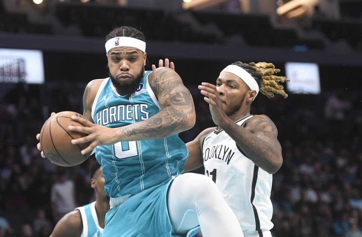 Oct 22, 2025; Charlotte, North Carolina, USA;  Charlotte Hornets forward Miles Bridges (0) gets a rebound during the first half against the Brooklyn Nets at the Spectrum Center. Mandatory Credit: Sam Sharpe-Imagn Images
