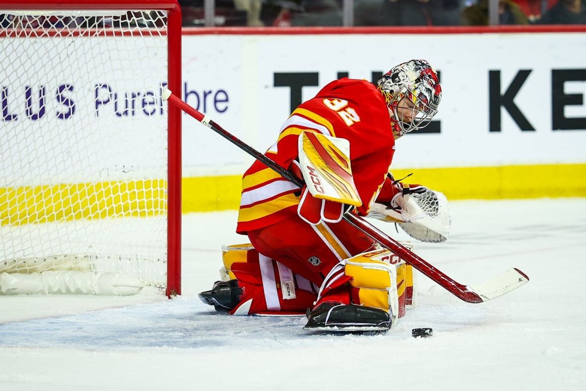 Oct 22, 2025; Calgary, Alberta, CAN; Calgary Flames goaltender Dustin Wolf (32) makes a save against the Montreal Canadiens during the first period at Scotiabank Saddledome. Mandatory Credit: Sergei Belski-Imagn Images