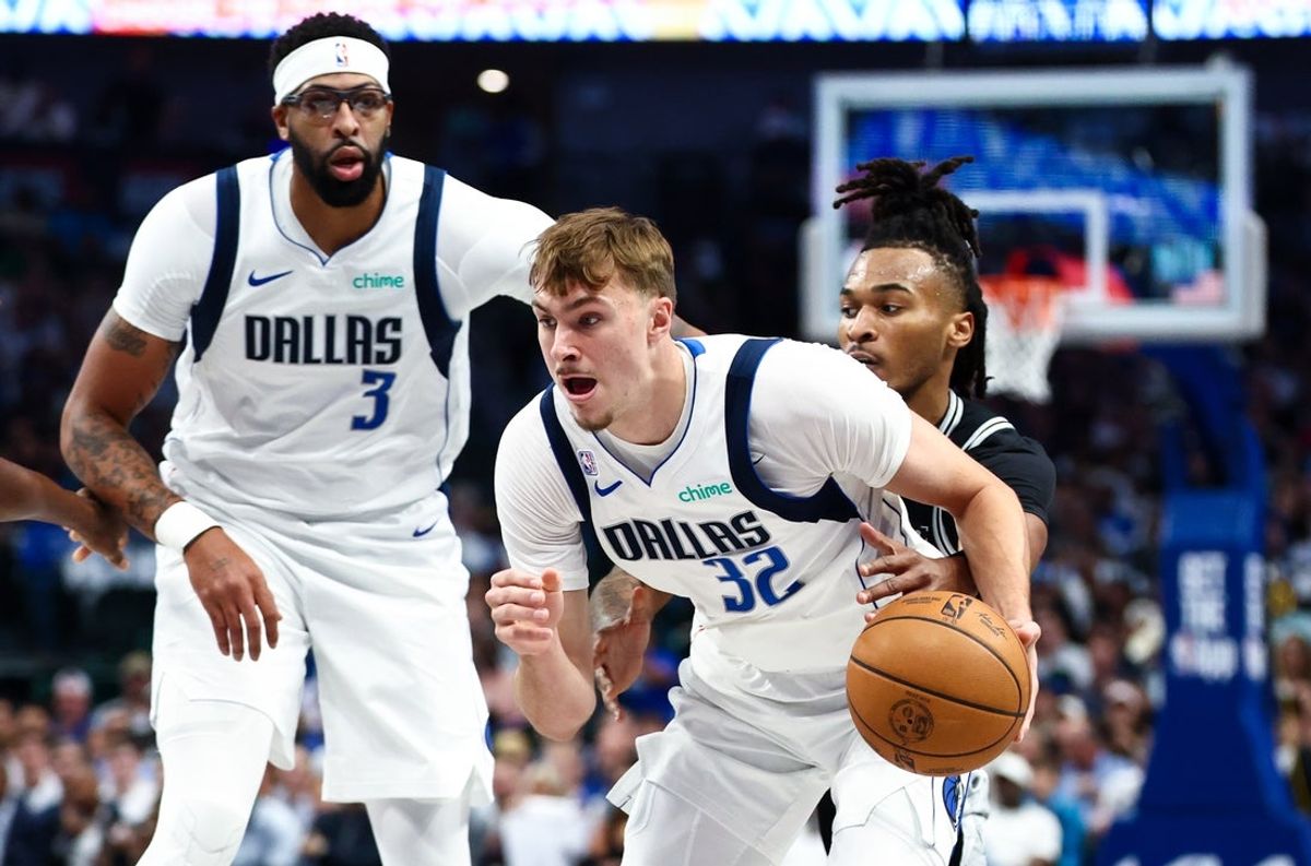 Oct 22, 2025; Dallas, Texas, USA;   Dallas Mavericks forward Cooper Flagg (32) dribbles as San Antonio Spurs guard Stephon Castle (5) defends during the first quarter at American Airlines Center. Mandatory Credit: Kevin Jairaj-Imagn Images
