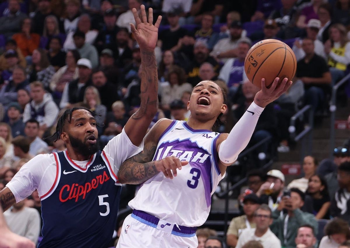Oct 22, 2025; Salt Lake City, Utah, USA; Utah Jazz guard Keyonte George (3) drives against Los Angeles Clippers forward Derrick Jones Jr. (5) during the second quarter at Delta Center. Mandatory Credit: Rob Gray-Imagn Images