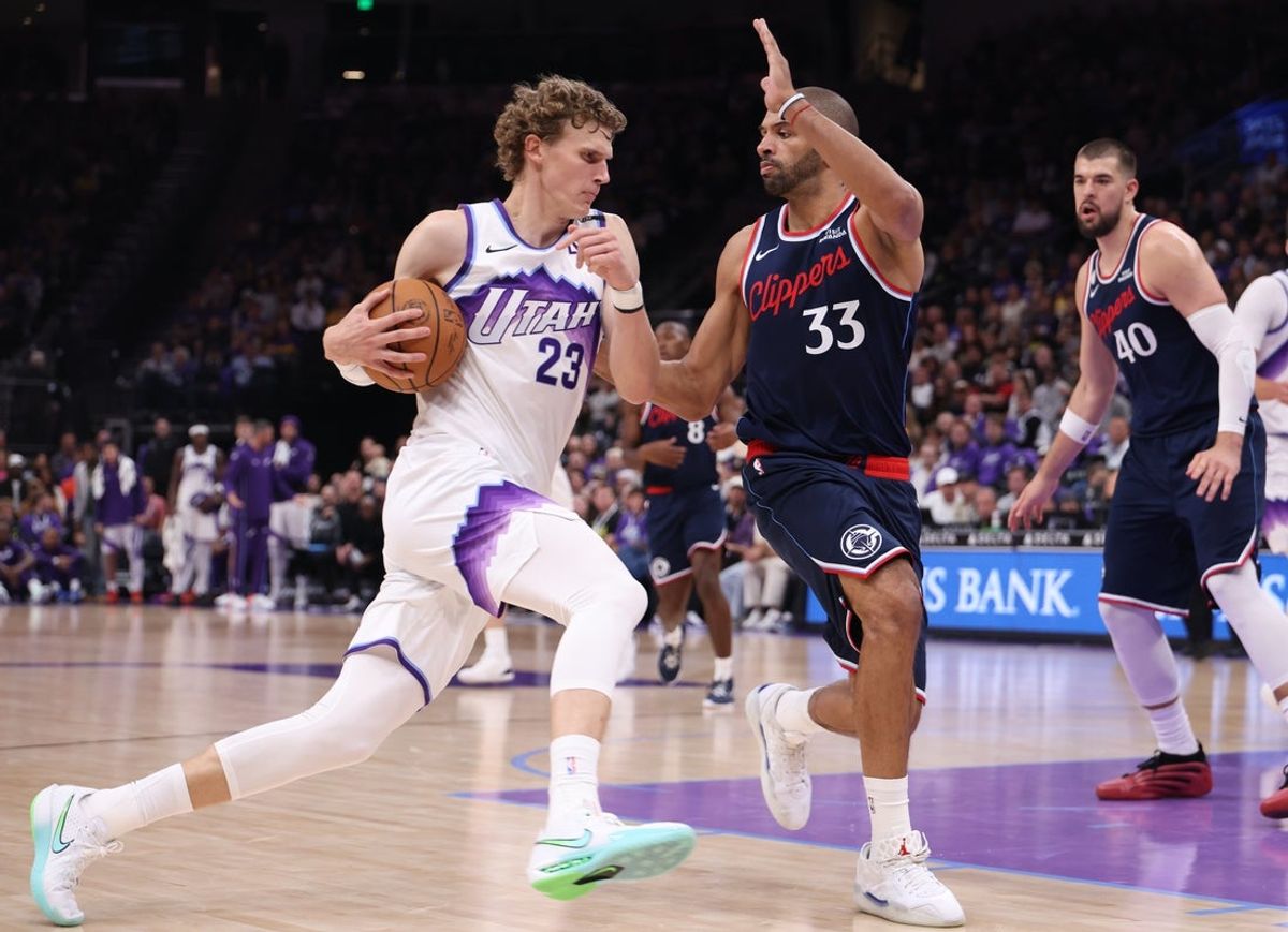 Oct 22, 2025; Salt Lake City, Utah, USA; Utah Jazz forward Lauri Markkanen (23) drives against Los Angeles Clippers forward Nicolas Batum (33) during the second quarter at Delta Center. Mandatory Credit: Rob Gray-Imagn Images