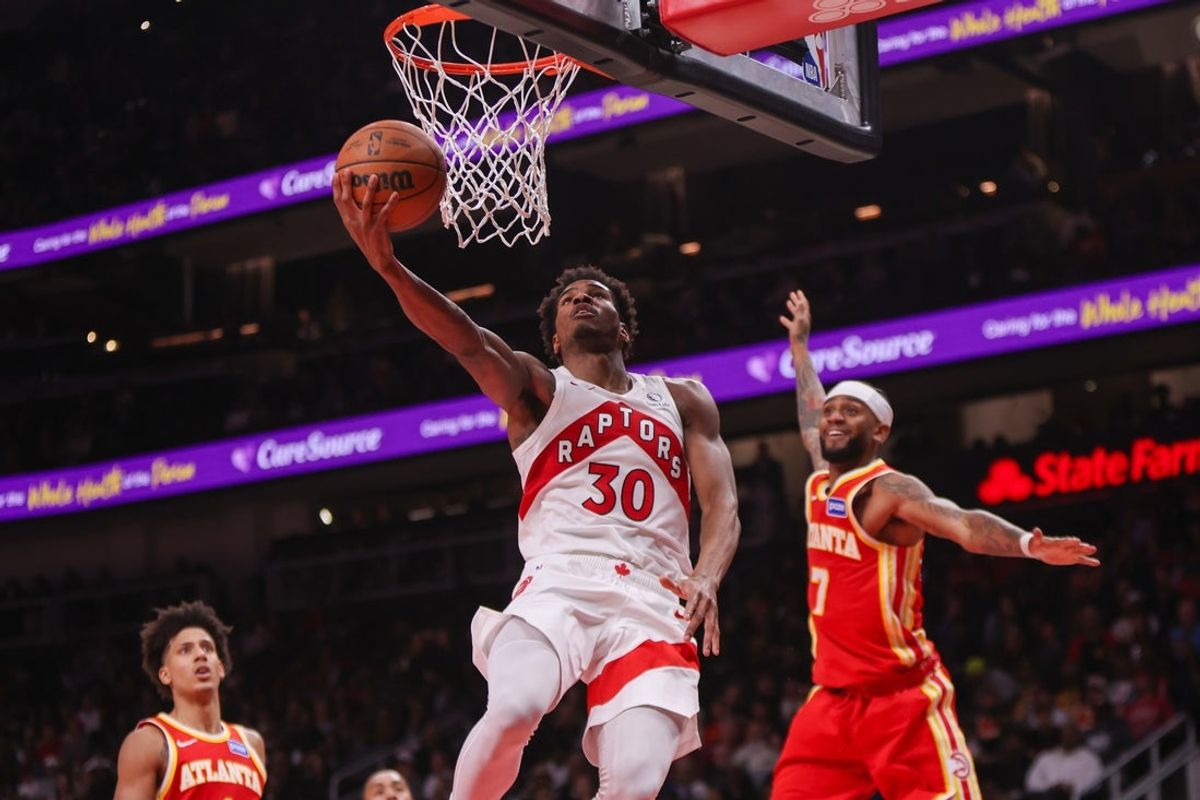 Oct 22, 2025; Atlanta, Georgia, USA; Toronto Raptors guard Ochai Agbaji (30) shoots past Atlanta Hawks guard Nickeil Alexander-Walker (7) in the fourth quarter at State Farm Arena. Mandatory Credit: Brett Davis-Imagn Images
