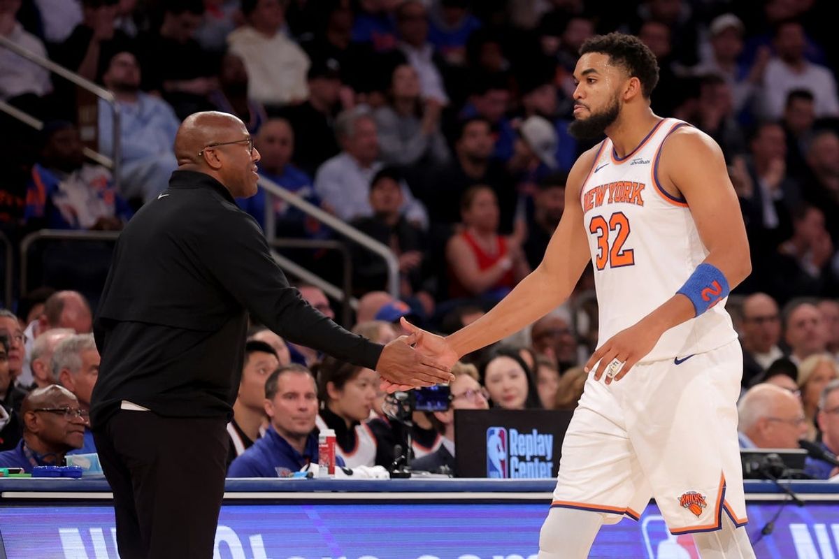 Oct 22, 2025; New York, New York, USA; New York Knicks head coach Mike Brown high fives center Karl-Anthony Towns (32) during the fourth quarter against the Cleveland Cavaliers at Madison Square Garden. Mandatory Credit: Brad Penner-Imagn Images