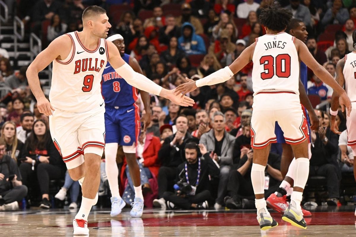 Oct 22, 2025; Chicago, Illinois, USA;  Chicago Bulls center Nikola Vucevic (9) high fives Chicago Bulls guard Tre Jones (30) after he scores an three point basket against the Detroit Pistons during the second half at United Center. Mandatory Credit: Matt Marton-Imagn Images