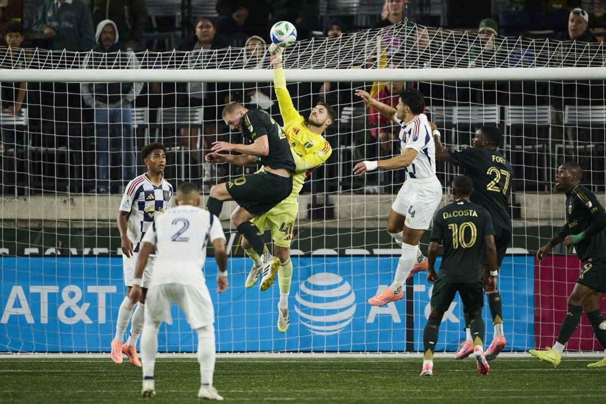 Oct 22, 2025; Portland, Oregon, USA; Portland Timbers goalkeeper James Pantemis (41) punches the ball away during the first half against Real Salt Lake defender Brayan Vera (4) at Providence Park. Mandatory Credit: Troy Wayrynen-Imagn Images