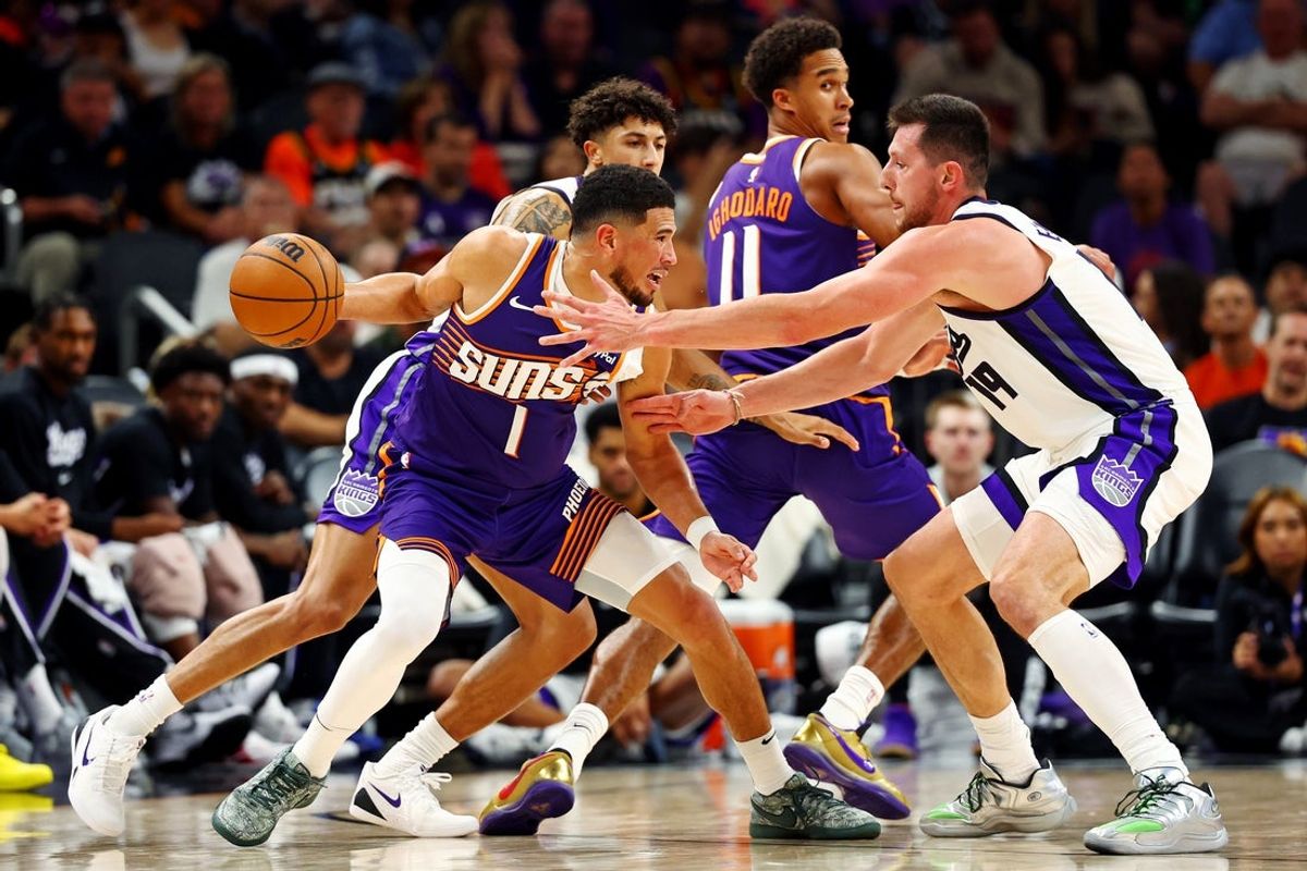 Oct 22, 2025; Phoenix, Arizona, USA; Phoenix Suns guard Devin Booker (1) handles the ball against Sacramento Kings forward Drew Eubanks (19) during the second half at the Mortgage Matchup Center. Mandatory Credit: Mark J. Rebilas-Imagn Images