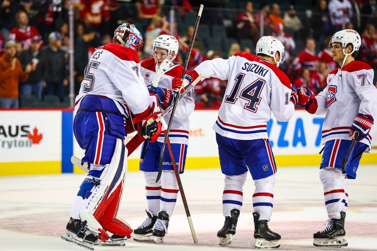 Oct 22, 2025; Calgary, Alberta, CAN; Montreal Canadiens players collide win over the Calgary Flames during the overtime period at Scotiabank Saddledome. Mandatory Credit: Sergei Belski-Imagn Images