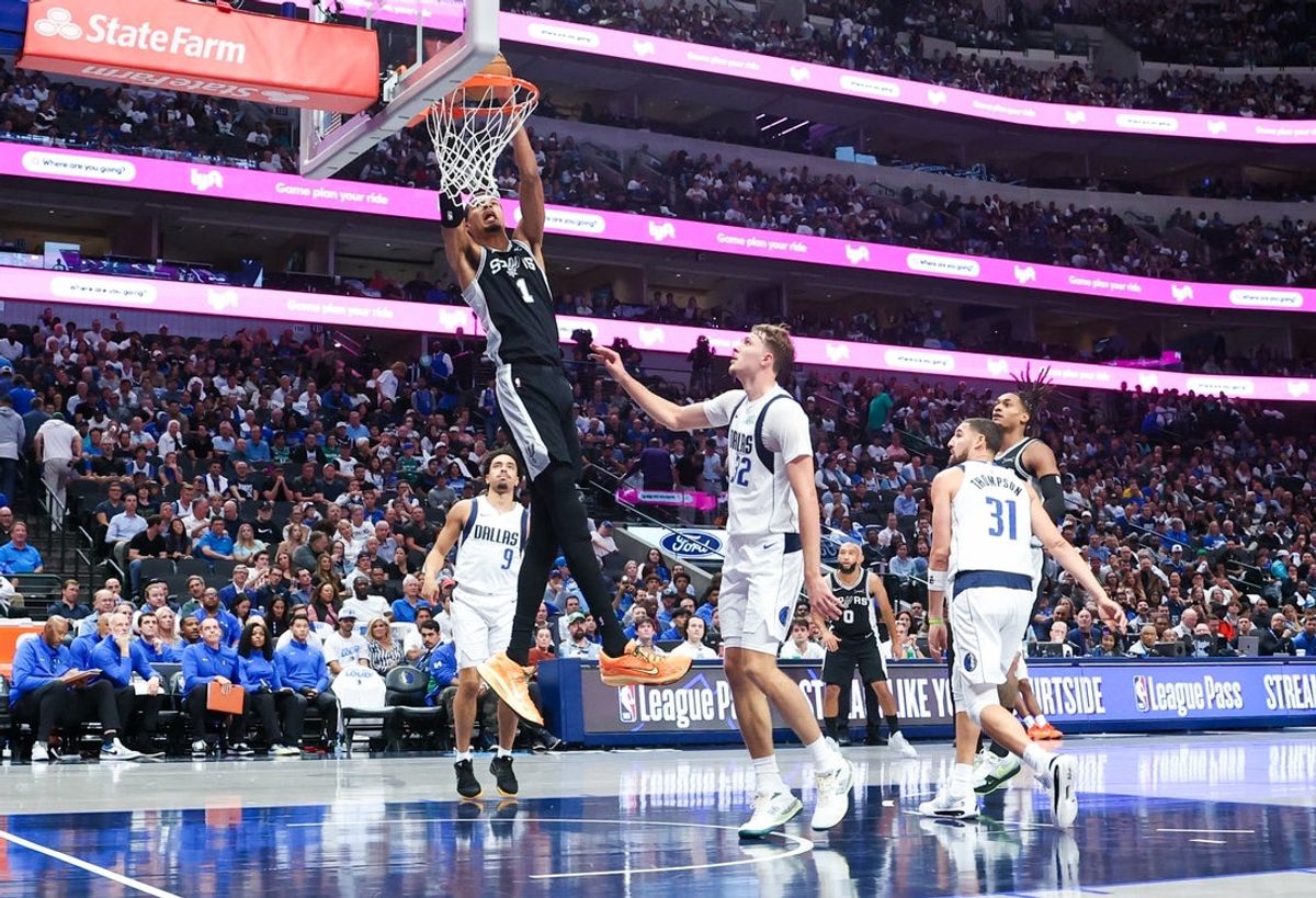 Oct 22, 2025; Dallas, Texas, USA;   San Antonio Spurs forward Victor Wembanyama (1) dunks past Dallas Mavericks forward Cooper Flagg (32) during the second half at American Airlines Center. Mandatory Credit: Kevin Jairaj-Imagn Images