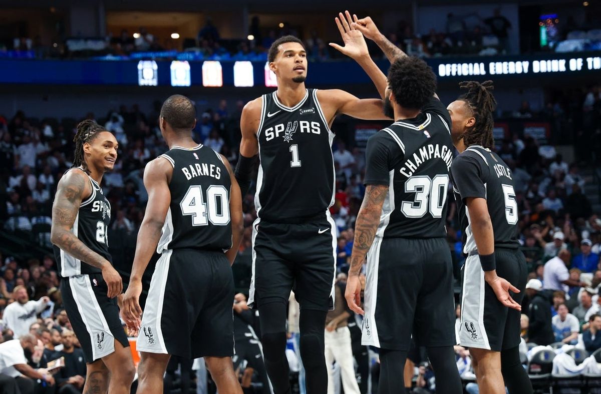 Oct 22, 2025; Dallas, Texas, USA;   San Antonio Spurs forward Victor Wembanyama (1) celebrates with San Antonio Spurs forward Julian Champagnie (30) and San Antonio Spurs guard Stephon Castle (5) and San Antonio Spurs forward Harrison Barnes (40) during the second half against the Dallas Mavericks at American Airlines Center. Mandatory Credit: Kevin Jairaj-Imagn Images