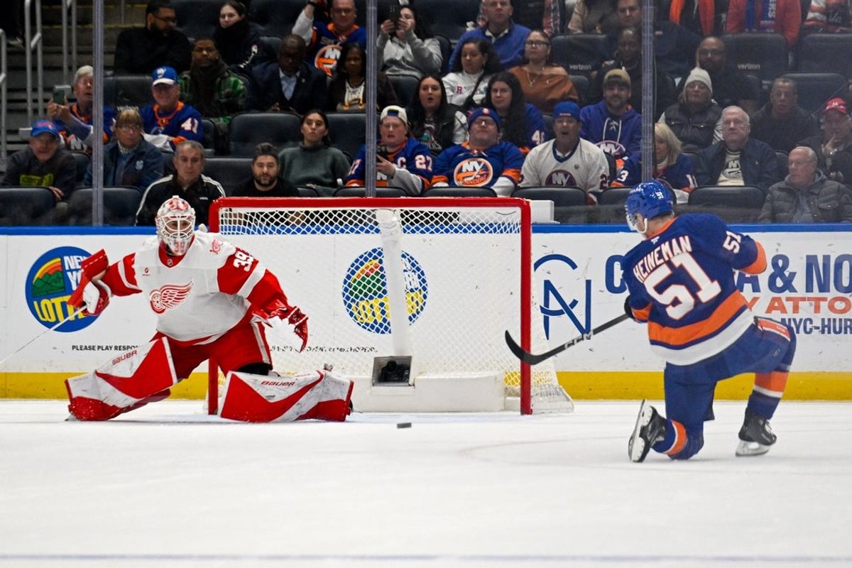 Oct 23, 2025; Elmont, New York, USA;  New York Islanders left wing Emil Heineman (51) scores a goal past Detroit Red Wings goaltender Cam Talbot (39) during the first period at UBS Arena. Mandatory Credit: Dennis Schneidler-Imagn Images