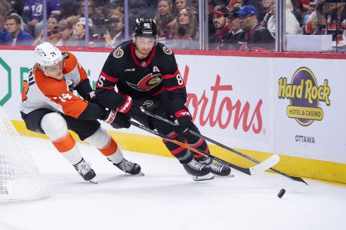 Oct 23, 2025; Ottawa, Ontario, CAN; Philadelphia Flyers right wing Owen Tippett (74) and Ottawa Senators defenseman Jake Sanderson (85) battle for control of the puck in the second period at the Canadian Tire Centre. Mandatory Credit: Marc DesRosiers-IMAGN Images