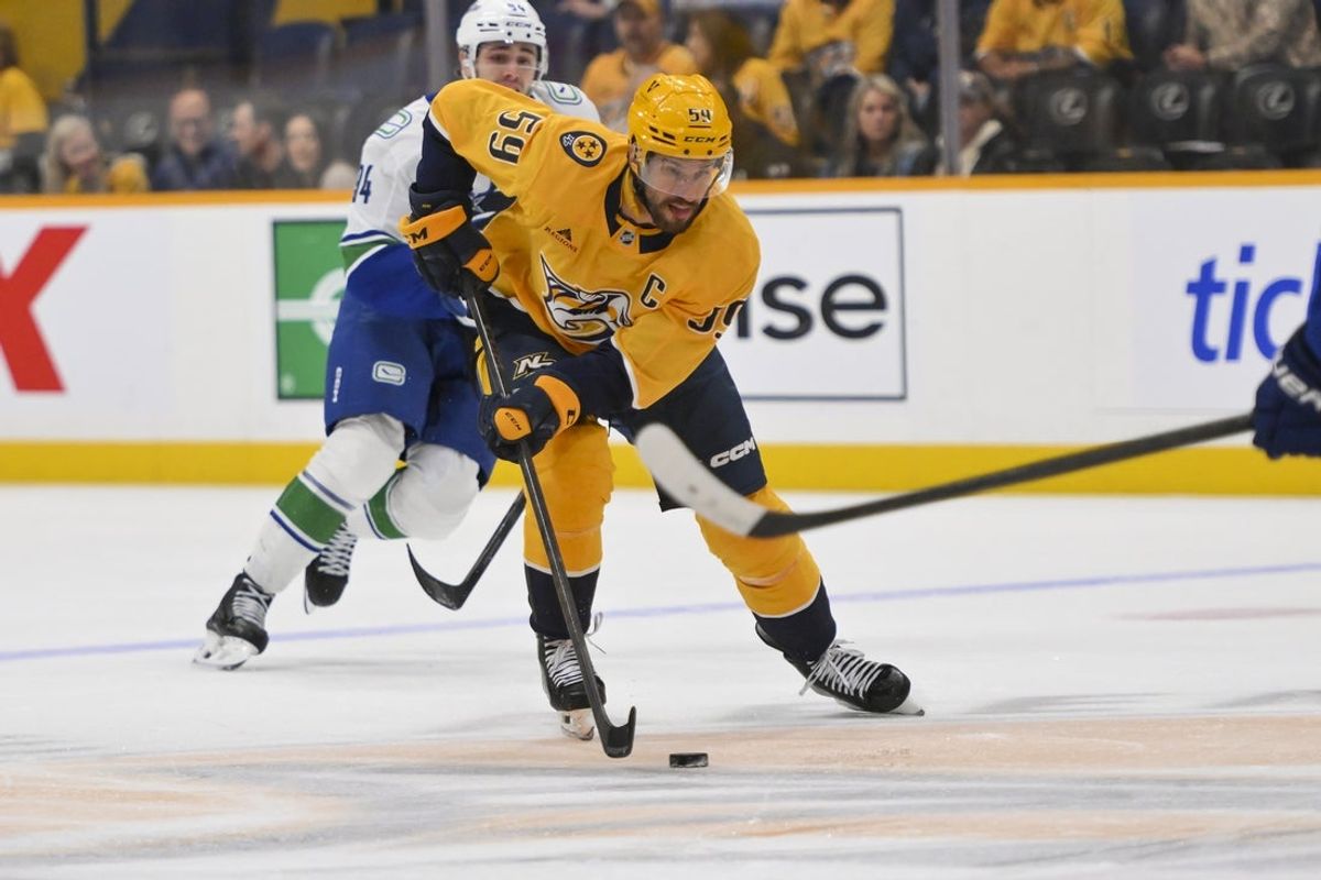 Oct 23, 2025; Nashville, Tennessee, USA;  Nashville Predators defenseman Roman Josi (59) skates with the puck against the Vancouver Canucks during the first period at Bridgestone Arena. Mandatory Credit: Steve Roberts-Imagn Images