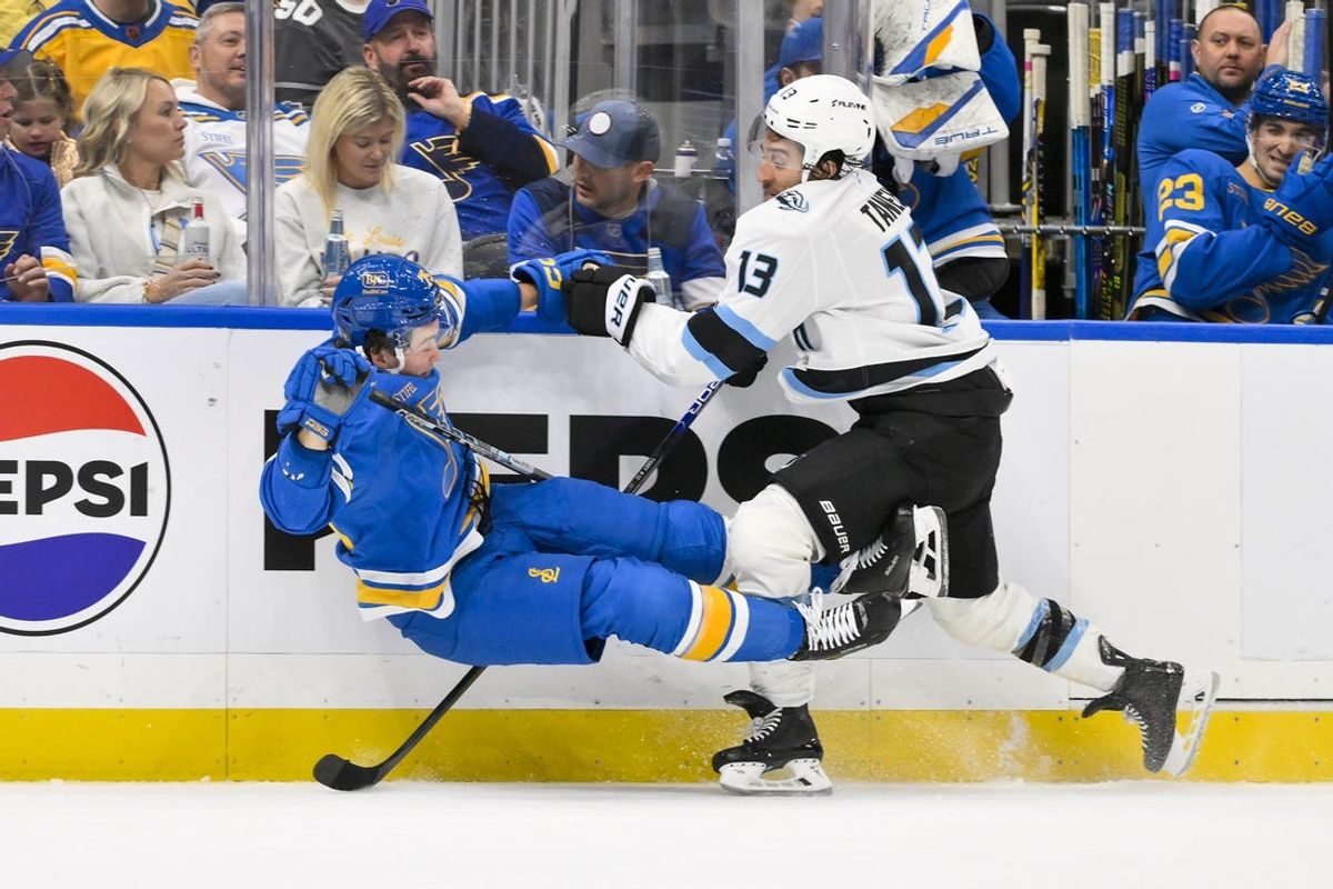 Oct 23, 2025; St. Louis, Missouri, USA; Utah Mammoth left wing Brandon Tanev (13) checks St. Louis Blues defenseman Tyler Tucker (75) during the first period at Enterprise Center. Mandatory Credit: Jeff Curry-Imagn Images
