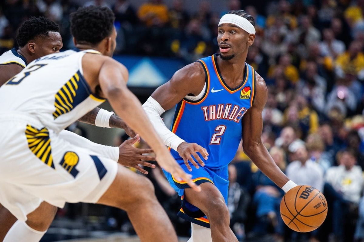 Oct 23, 2025; Indianapolis, Indiana, USA; Oklahoma City Thunder guard Shai Gilgeous-Alexander (2) dribbles the ball while Indiana Pacers guard Bennedict Mathurin (00) defends in the first half at Gainbridge Fieldhouse. Mandatory Credit: Trevor Ruszkowski-Imagn Images