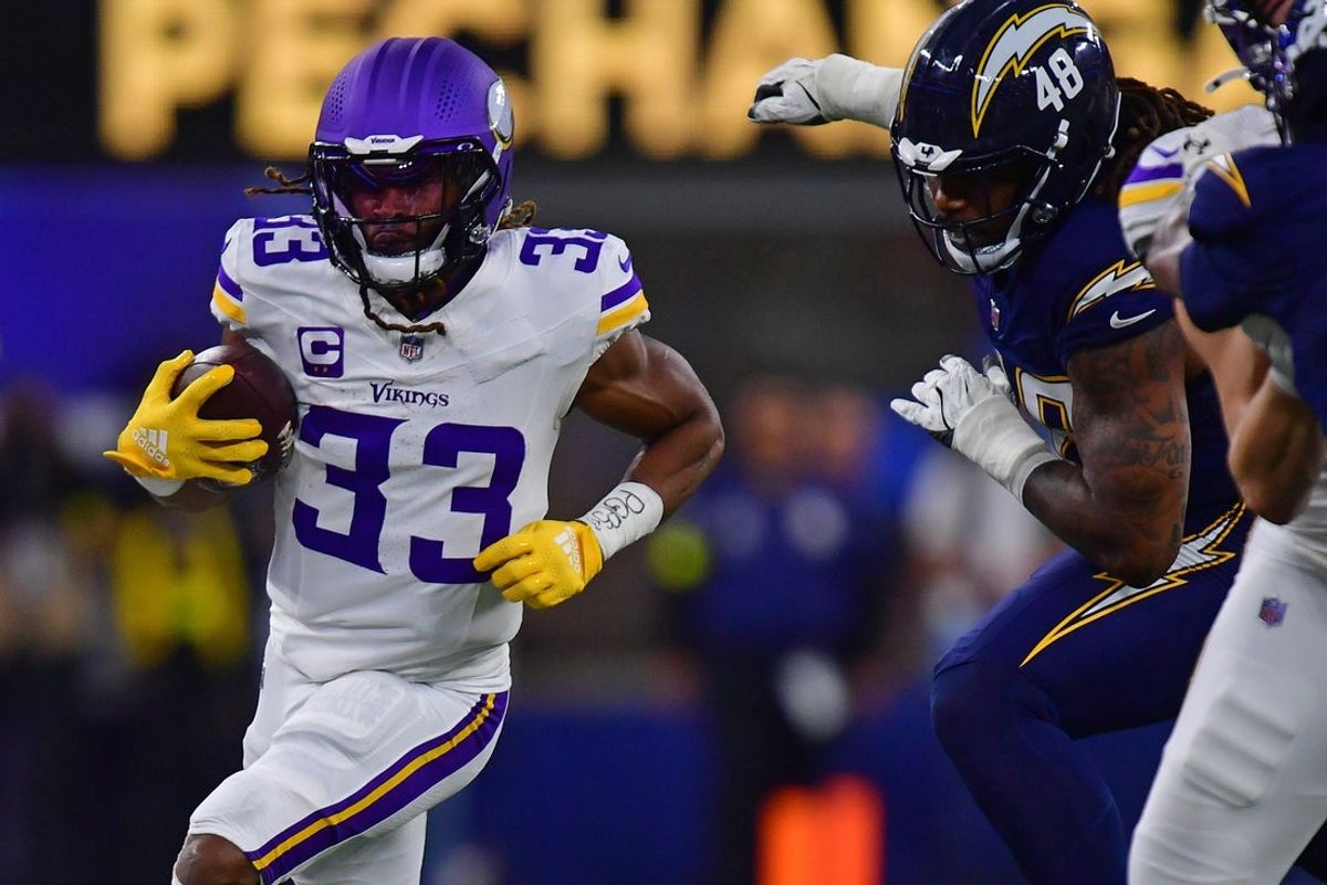 Oct 23, 2025; Inglewood, California, USA; Minnesota Vikings running back Aaron Jones Sr. (33) rushes the ball against the Los Angeles Chargers during the first half at SoFi Stadium. Mandatory Credit: Gary A. Vasquez-Imagn Images