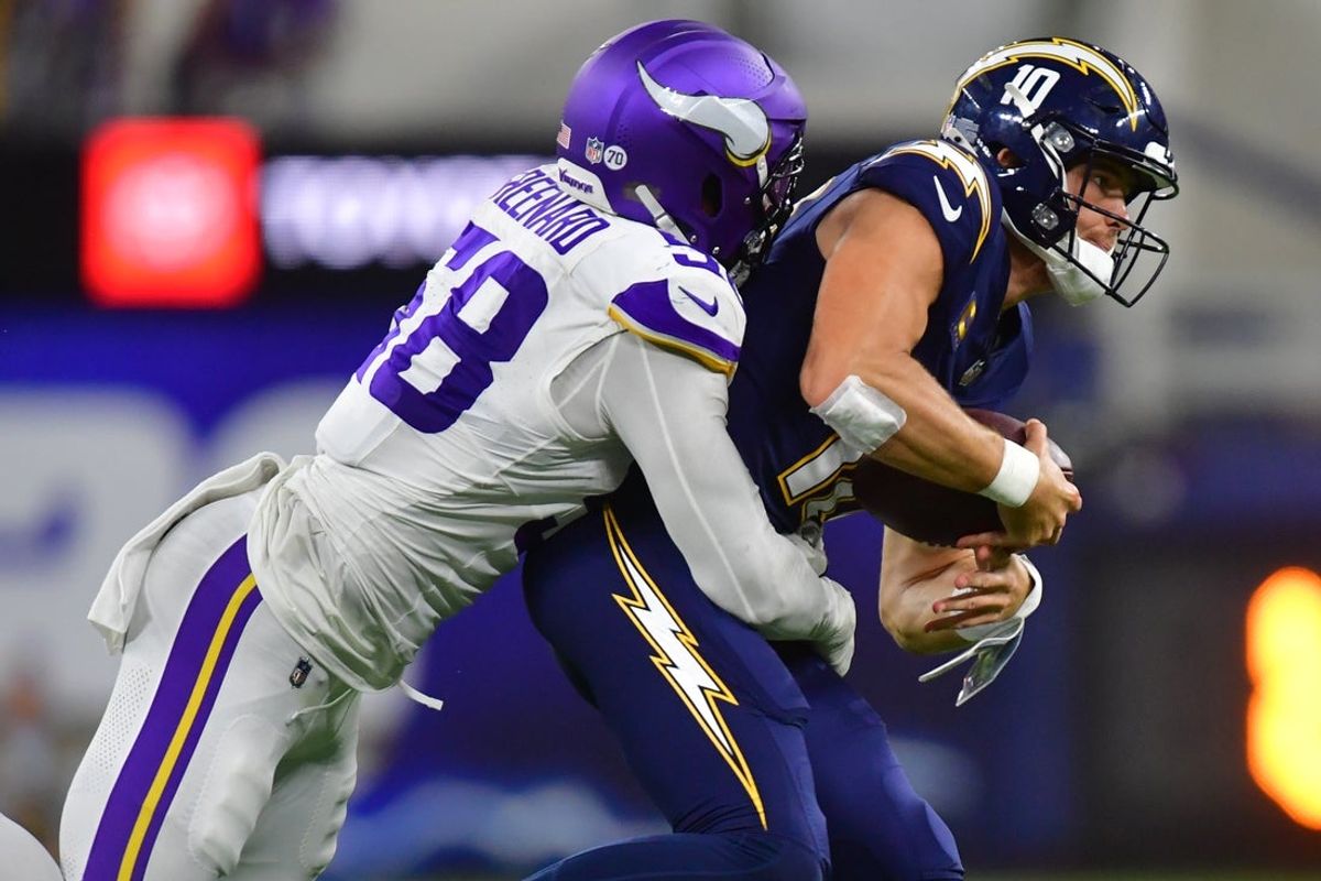 Oct 23, 2025; Inglewood, California, USA; Minnesota Vikings linebacker Jonathan Greenard (58) gets pressure on Los Angeles Chargers quarterback Justin Herbert (10) during the first half at SoFi Stadium. Mandatory Credit: Gary A. Vasquez-Imagn Images