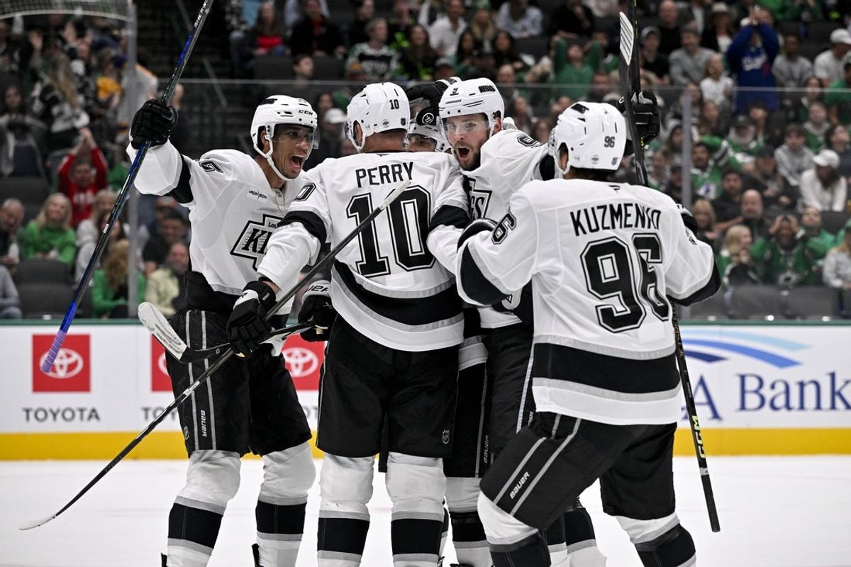 Oct 23, 2025; Dallas, Texas, USA; Los Angeles Kings right wing Quinton Byfield (55) and right wing Corey Perry (10) and right wing Adrian Kempe (9) left wing Andrei Kuzmenko (96) celebrates a power play goal scored by Perry against the Dallas Stars during the first period at the American Airlines Center. Mandatory Credit: Jerome Miron-Imagn Images