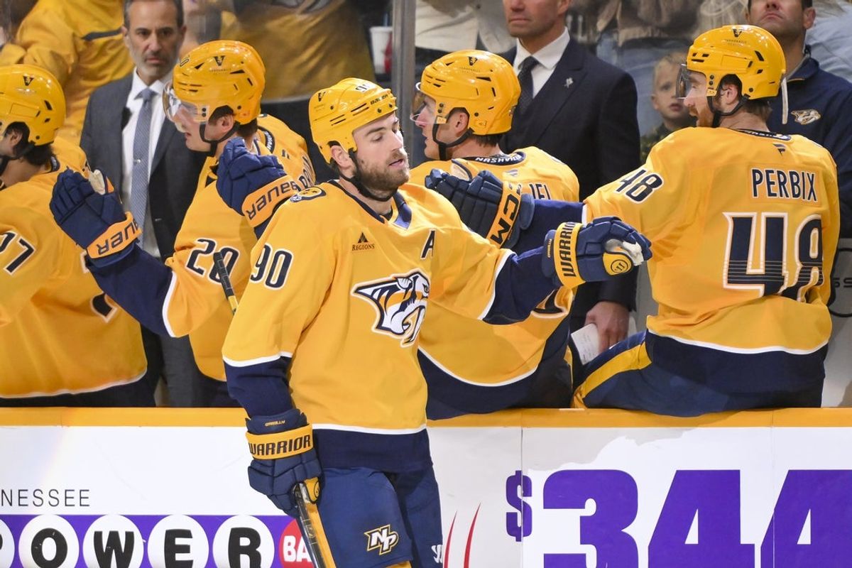 Oct 23, 2025; Nashville, Tennessee, USA;  Nashville Predators center Ryan O'Reilly (90) celebrates with his teammates after scoring a goal against the Vancouver Canucks during the second period at Bridgestone Arena. Mandatory Credit: Steve Roberts-Imagn Images