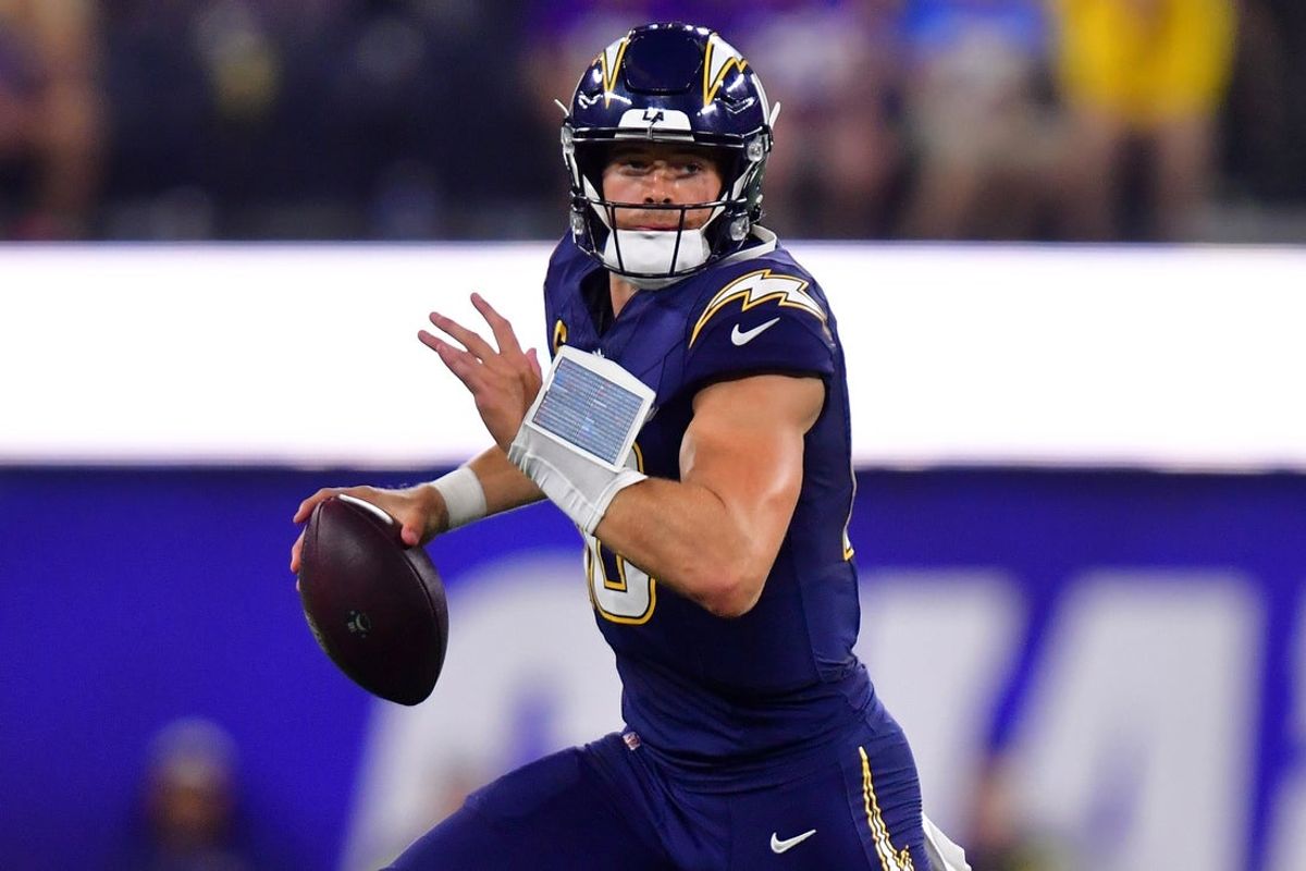 Oct 23, 2025; Inglewood, California, USA; Los Angeles Chargers quarterback Justin Herbert (10) rushes the ball against the Minnesota Vikings during the second half at SoFi Stadium. Mandatory Credit: Gary A. Vasquez-Imagn Images