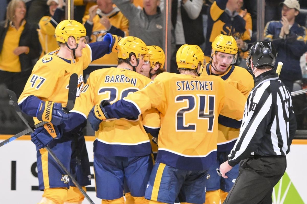 Oct 23, 2025; Nashville, Tennessee, USA;  Nashville Predators left wing Cole Smith (36) celebrates with his teammates after scoring a goal against the Vancouver Canucks during the third period at Bridgestone Arena. Mandatory Credit: Steve Roberts-Imagn Images