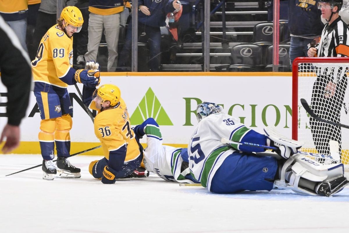 Nashville Predators left wing Cole Smith (36) celebrates with right wing Ozzy Weisblatt (89) scoring his goal against the Vancouver Canucks Oct 23, 2025; Nashville, Tennessee, USA;  during the third period at Bridgestone Arena. Mandatory Credit: Steve Roberts-Imagn Images