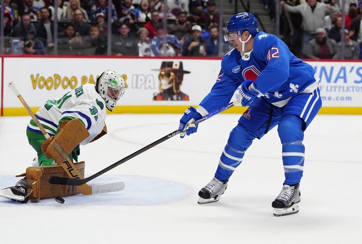 Oct 23, 2025; Denver, Colorado, USA; Carolina Hurricanes goaltender Frederik Andersen (31) makes a save on Colorado Avalanche defenseman Josh Manson (42) in the second period at Ball Arena. Mandatory Credit: Ron Chenoy-Imagn Images
