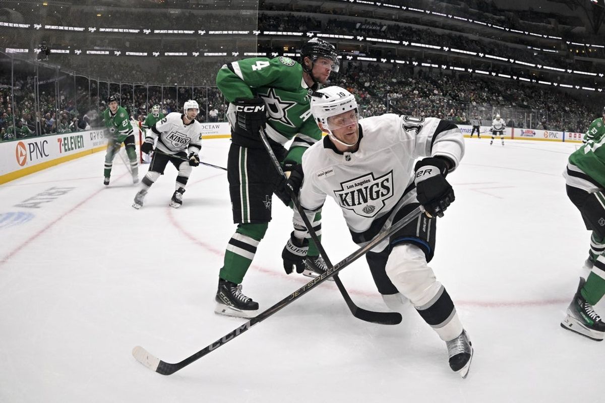 Oct 23, 2025; Dallas, Texas, USA; Dallas Stars defenseman Miro Heiskanen (4) and Los Angeles Kings right wing Corey Perry (10) battle for control of the puck during the third period at the American Airlines Center. Mandatory Credit: Jerome Miron-Imagn Images