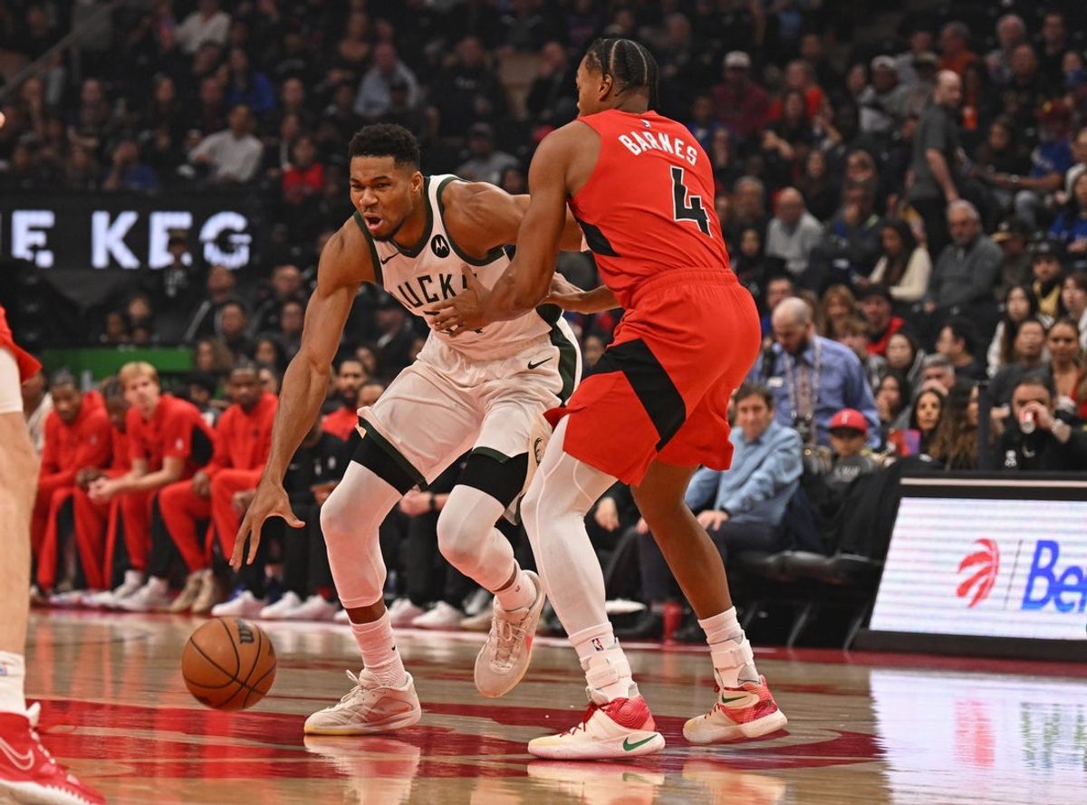 Oct 24, 2025; Toronto, Ontario, CAN; Milwaukee Bucks forward Giannis Antetokounmpo (34) dribbles against Toronto Raptors forward Scottie Barnes (4) in the first quarter at Scotiabank Arena. Mandatory Credit: Gerry Angus-Imagn Images