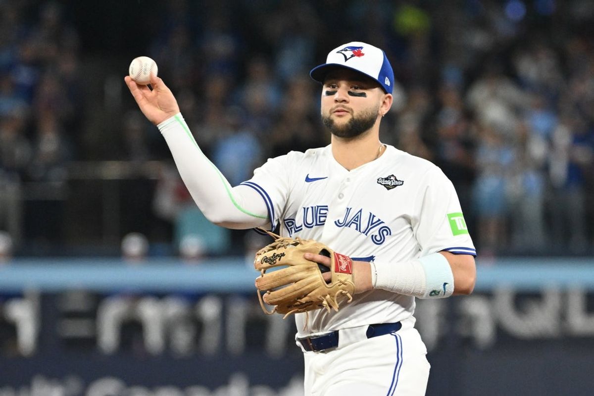 Oct 24, 2025; Toronto, Ontario, CAN; Toronto Blue Jays second baseman Bo Bichette (11) makes a play to get out Los Angeles Dodgers first baseman Freddie Freeman (not pictured) in the first inning during game one of the 2025 MLB World Series at Rogers Centre. Mandatory Credit: Dan Hamilton-Imagn Images