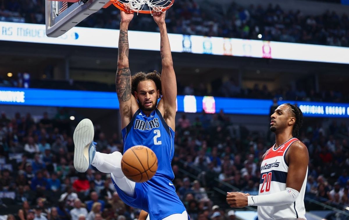 Oct 24, 2025; Dallas, Texas, USA; Dallas Mavericks center Dereck Lively II (2) dunks past Washington Wizards center Alex Sarr (20) during the first quarter at American Airlines Center. Mandatory Credit: Kevin Jairaj-Imagn Images