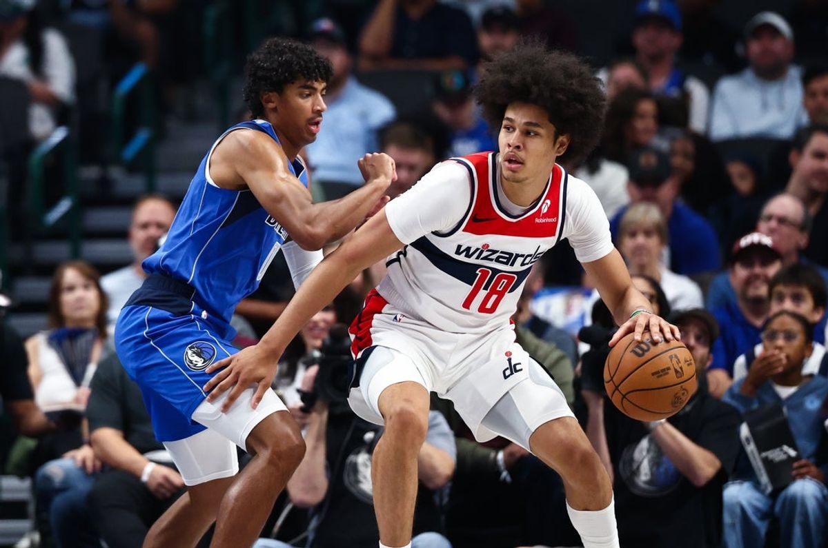 Oct 24, 2025; Dallas, Texas, USA;  Washington Wizards forward Kyshawn George (18) dribbles as Dallas Mavericks guard Max Christie (00) defends during the first quarter at American Airlines Center. Mandatory Credit: Kevin Jairaj-Imagn Images