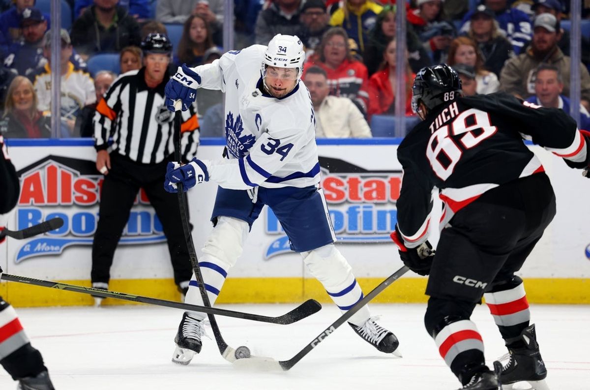 Oct 24, 2025; Buffalo, New York, USA;  Buffalo Sabres right wing Alex Tuch (89) blocks a shot by Toronto Maple Leafs center Auston Matthews (34) with his stick during the third period at KeyBank Center. Mandatory Credit: Timothy T. Ludwig-Imagn Images