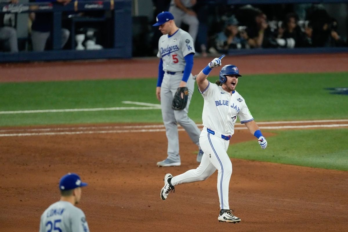 Oct 24, 2025; Toronto, Ontario, CAN; Toronto Blue Jays right fielder Addison Barger (47) celebrates as he rounds the bases after hitting a grand slam as Los Angeles Dodgers first baseman Freddie Freeman (5) and second baseman Tommy Edman (25) look on in the sixth inning during game one of the 2025 MLB World Series at Rogers Centre. Mandatory Credit: Kevin Sousa-Imagn Images