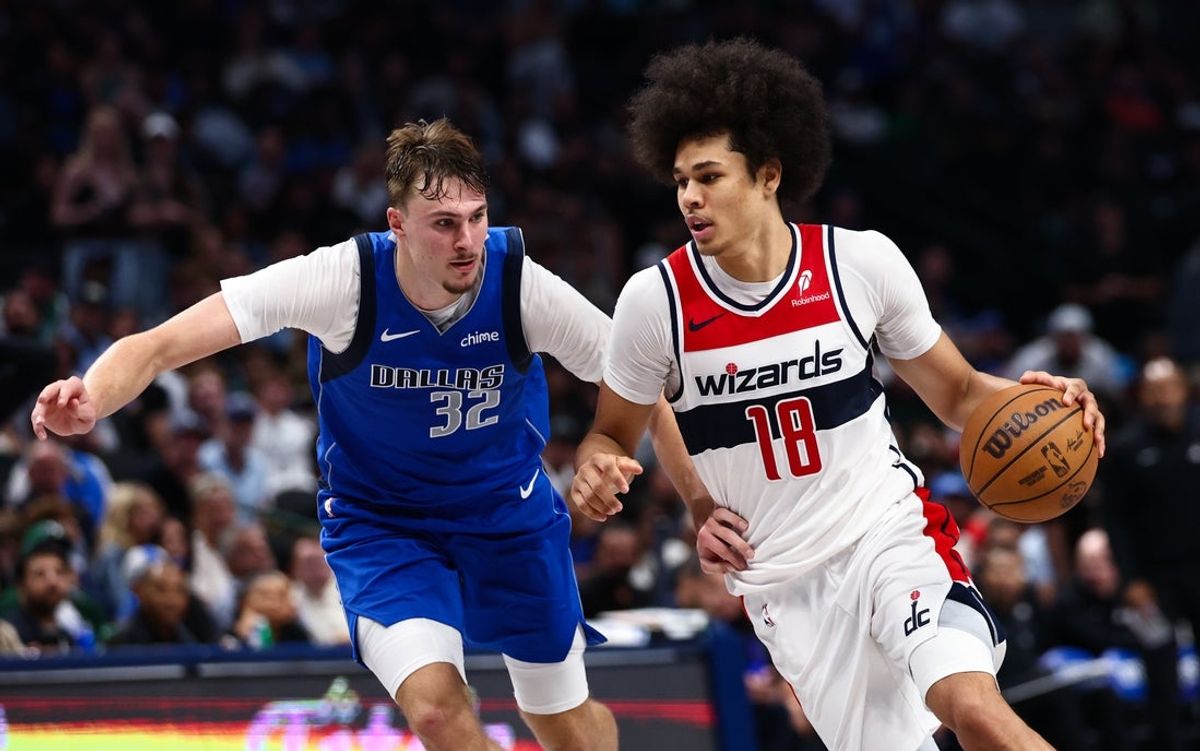 Oct 24, 2025; Dallas, Texas, USA;  Washington Wizards forward Kyshawn George (18) drives to the basket as Dallas Mavericks forward Cooper Flagg (32) defends during the second half at American Airlines Center. Mandatory Credit: Kevin Jairaj-Imagn Images