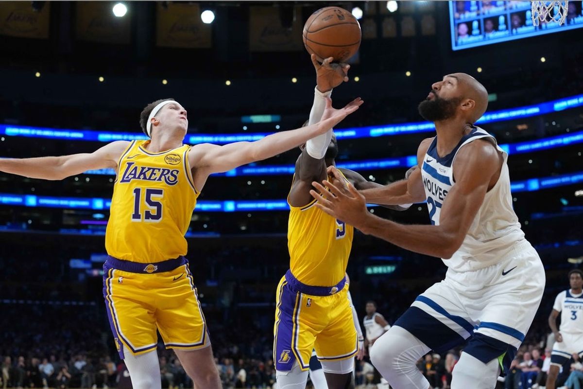 Oct 24, 2025; Los Angeles, California, USA; Los Angeles Lakers guard Austin Reaves (15) and center Deandre Ayton (5) battle for the ball with Minnesota Timberwolves center Rudy Gobert (27) in the first half at Crypto.com Arena. Mandatory Credit: Kirby Lee-Imagn Images