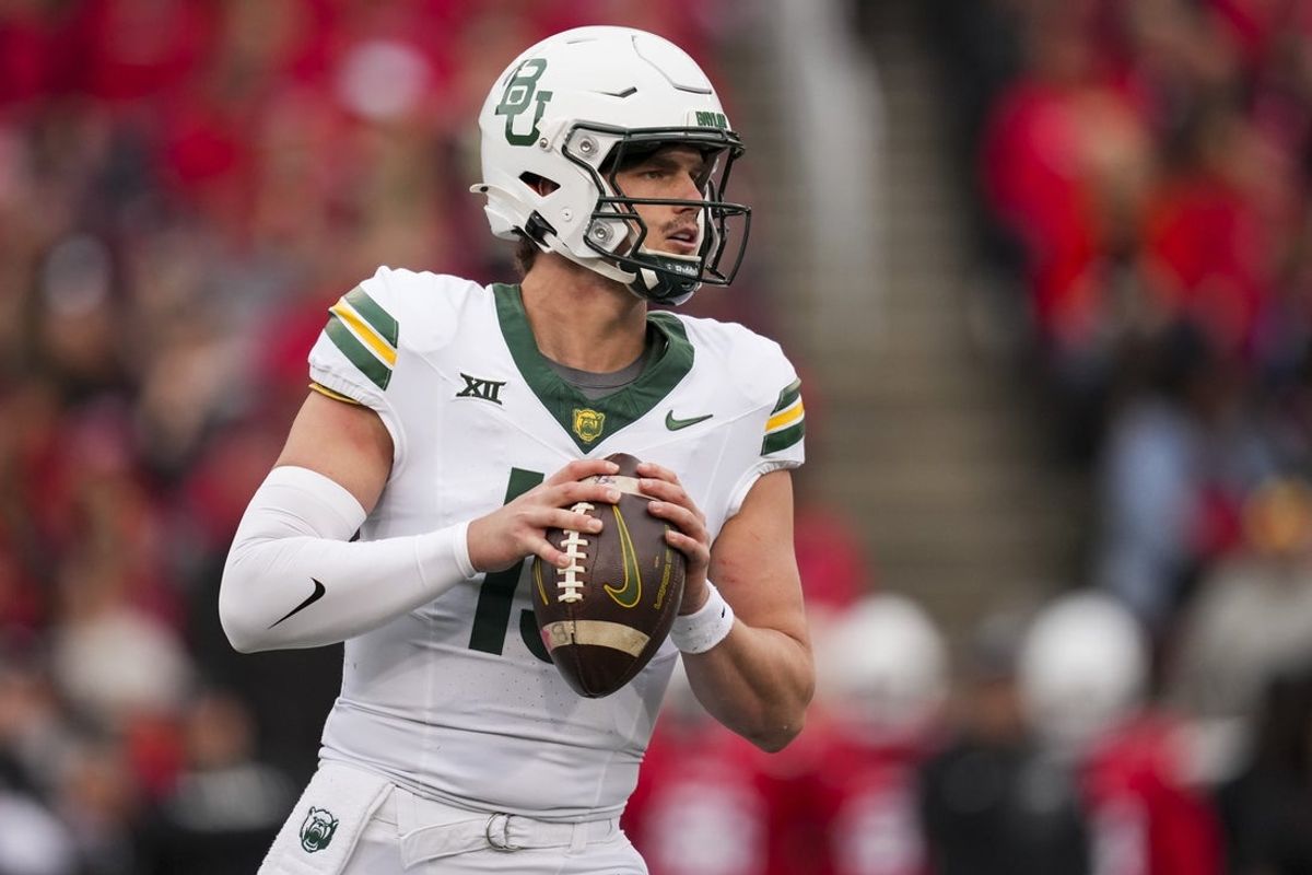 Oct 25, 2025; Cincinnati, Ohio, USA;  Baylor Bears quarterback Sawyer Robertson (13) drops back to pass against the Cincinnati Bearcats in the first half at Nippert Stadium. Mandatory Credit: Aaron Doster-Imagn Images