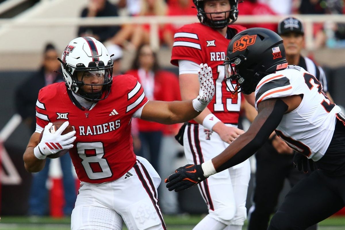 Oct 25, 2025; Lubbock, Texas, USA;  Texas Tech Red Raiders running back Cameron Dickey (8) stiff arms Oklahoma State Cowboys defensive back Trip White (30) in the first half at Jones AT&T Stadium. Mandatory Credit: Michael C. Johnson-Imagn Images