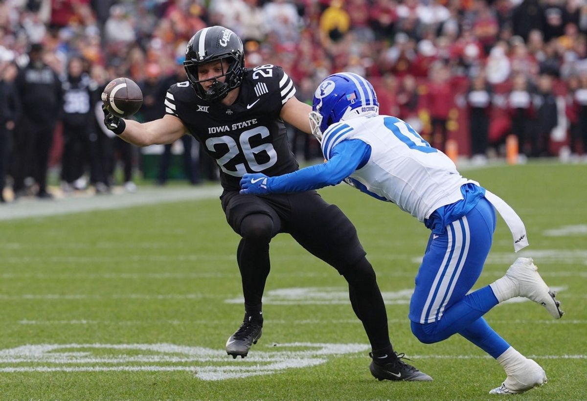 Iowa State Cyclones' running back Carson Hansen (26) attempts for the catch around BYU Cougars cornerback Evan Johnson (0) during the first quarter at Jack Trice Stadium on Oct. 25, 2025, in Ames, Iowa.