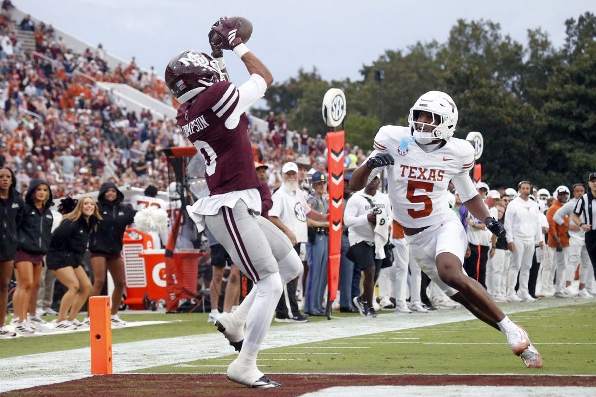 Oct 25, 2025; Starkville, Mississippi, USA; Mississippi State Bulldogs wide receiver Brenen Thompson (0) catches the ball for a touchdown over Texas Longhorns defensive back Malik Muhammad (5) during the second quarter at Davis Wade Stadium at Scott Field. Mandatory Credit: Petre Thomas-Imagn Images
