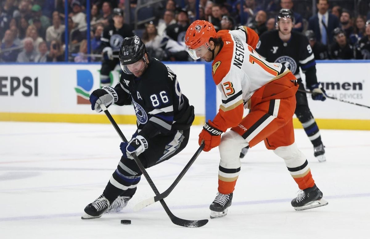 Oct 25, 2025; Tampa, Florida, USA; Tampa Bay Lightning right wing Nikita Kucherov (86) and Anaheim Ducks center Nikita Nesterenko (13) fight to control the puck during the third period at Benchmark International Arena. Mandatory Credit: Kim Klement Neitzel-Imagn Images