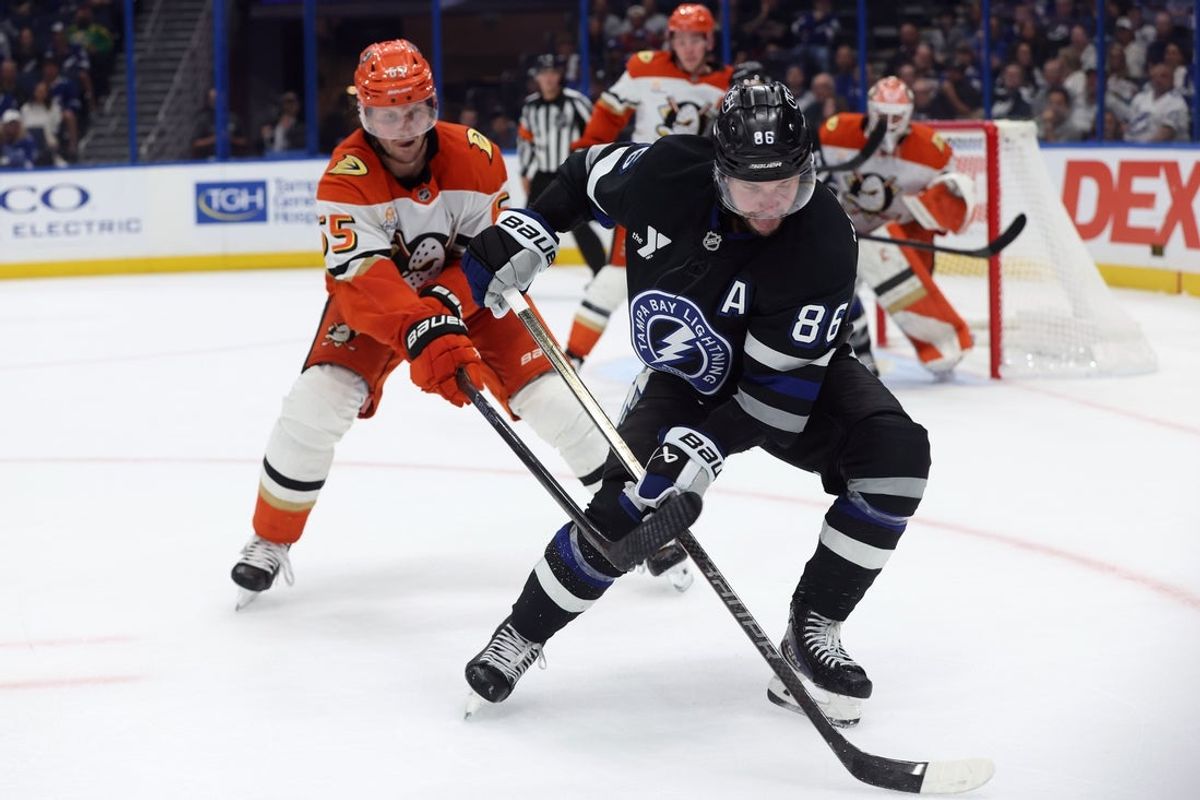 Oct 25, 2025; Tampa, Florida, USA; Tampa Bay Lightning right wing Nikita Kucherov (86) skates with the puck as Anaheim Ducks defenseman Jacob Trouba (65) defends during the third period at Benchmark International Arena. Mandatory Credit: Kim Klement Neitzel-Imagn Images
