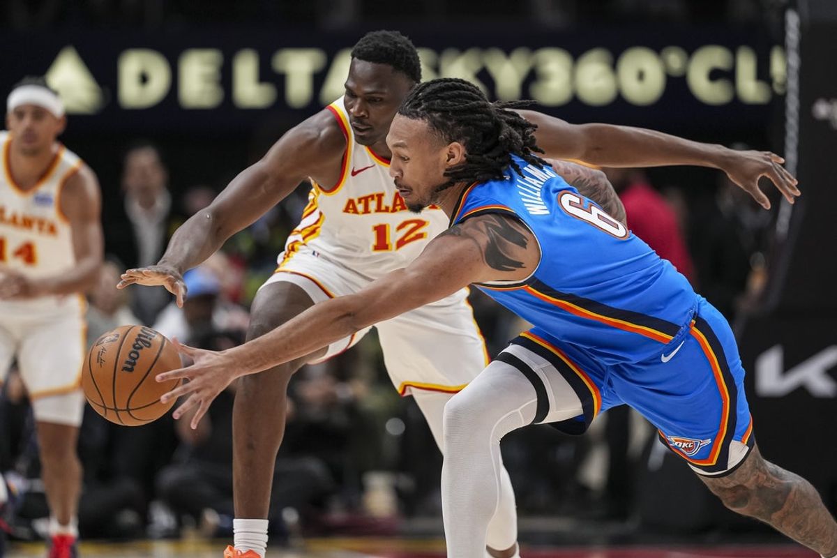 Oct 25, 2025; Atlanta, Georgia, USA; Atlanta Hawks center N'Faly Dante (12) and Oklahoma City Thunder forward Jaylin Williams (6) battle to control a loose ball during the first half at State Farm Arena. Mandatory Credit: Dale Zanine-Imagn Images