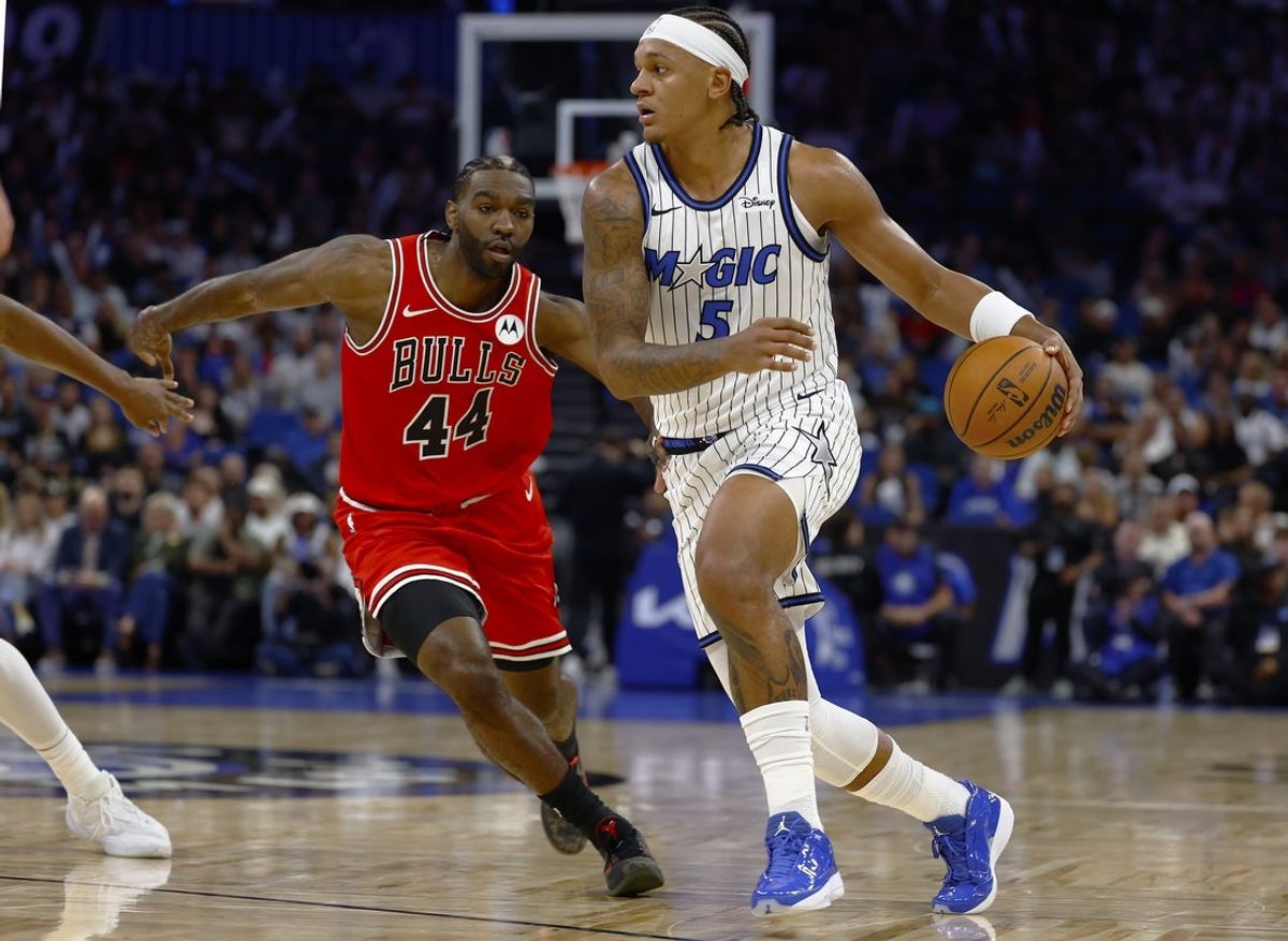 Oct 25, 2025; Orlando, Florida, USA;  Orlando Magic forward Paolo Banchero (5) /dribbles past Chicago Bulls forward Patrick Williams (44) in the first half at Kia Center. Mandatory Credit: Russell Lansford-Imagn Images