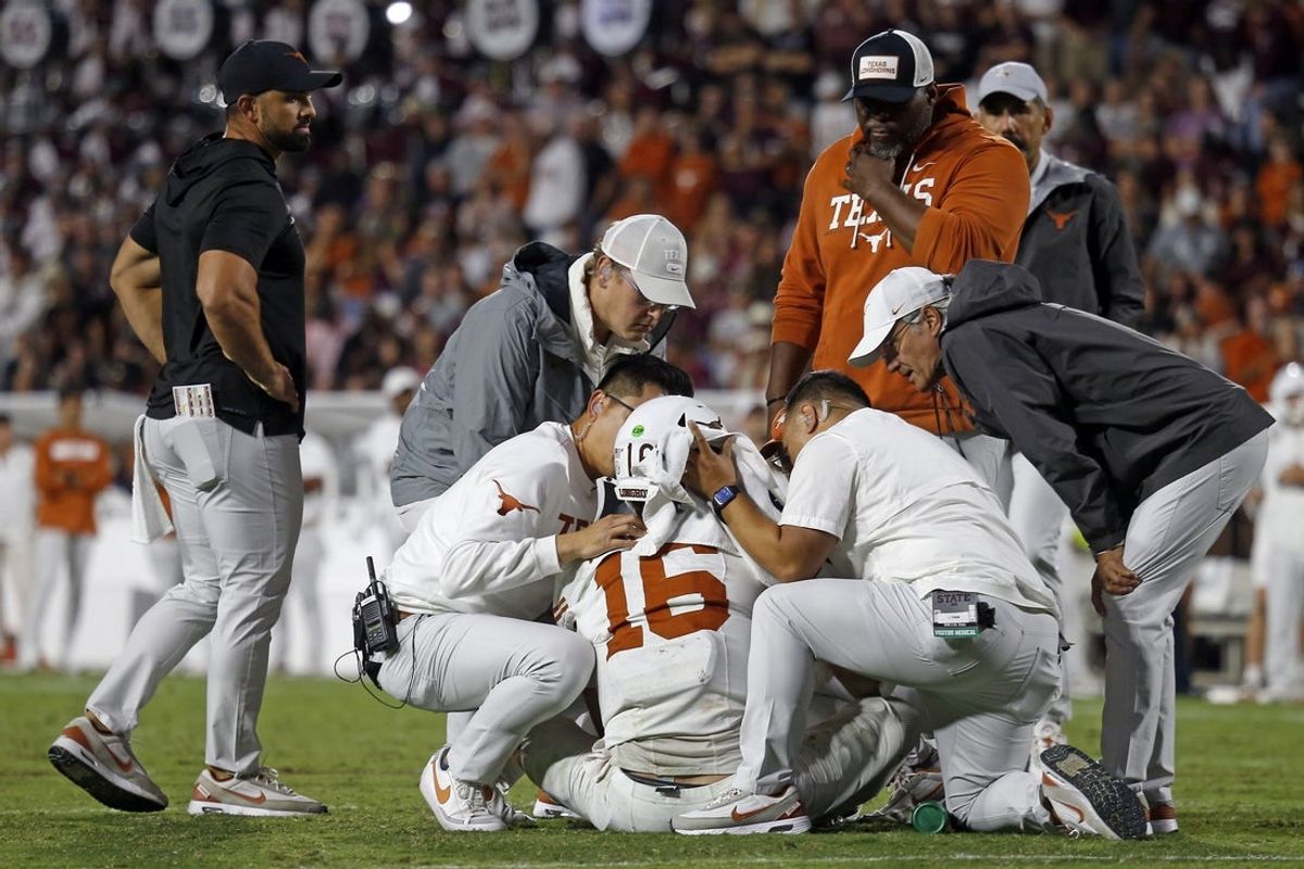 Oct 25, 2025; Starkville, Mississippi, USA; Medical staff check on Texas Longhorns quarterback Arch Manning (16) during overtime against the Mississippi State Bulldogs at Davis Wade Stadium at Scott Field. Mandatory Credit: Petre Thomas-Imagn Images