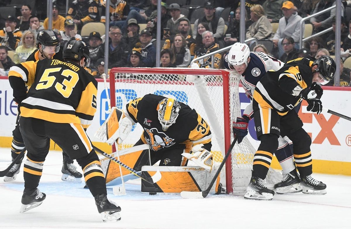 Oct 25, 2025; Pittsburgh, Pennsylvania, USA; Columbus Blue Jackets left wing Dmitri Voronkov (10) gets a shot off on Pittsburgh Penguins goalie Arturs Silovs (37) while under pressure from right wing Philip Tomasino (53) and defenseman Ryan Shea (5) during the second period action at PPG Paints Arena. Mandatory Credit: Philip G. Pavely-Imagn Images