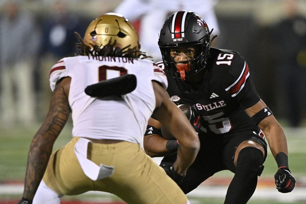 Oct 25, 2025; Louisville, Kentucky, USA;  Louisville Cardinals wide receiver Antonio Meeks (15) runs the ball against Boston College Eagles defensive back Omar Thornton (0) during the second quarter at L&N Federal Credit Union Stadium. Mandatory Credit: Jamie Rhodes-Imagn Images