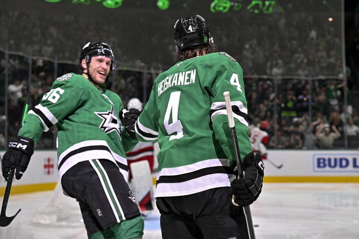 Oct 25, 2025; Dallas, Texas, USA; Dallas Stars right wing Mikko Rantanen (96) and defenseman Miro Heiskanen (4) celebrates a goal scored by Heiskanen against the Carolina Hurricanes during the second period at the American Airlines Center. Mandatory Credit: Jerome Miron-Imagn Images