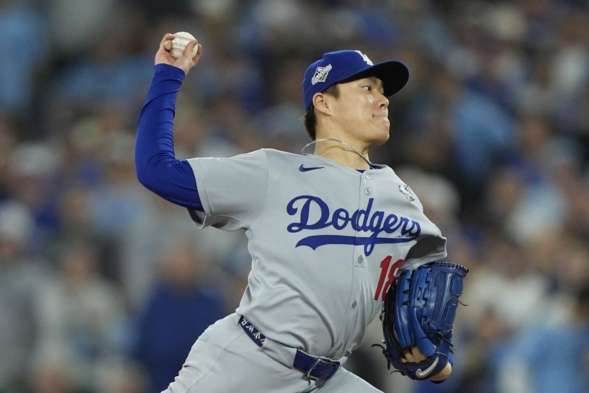 Oct 25, 2025; Toronto, Ontario, CAN; Los Angeles Dodgers pitcher Yoshinobu Yamamoto (18) pitches against the Toronto Blue Jays in the eighth inning during game two of the 2025 MLB World Series at Rogers Centre. Mandatory Credit: John E. Sokolowski-Imagn Images