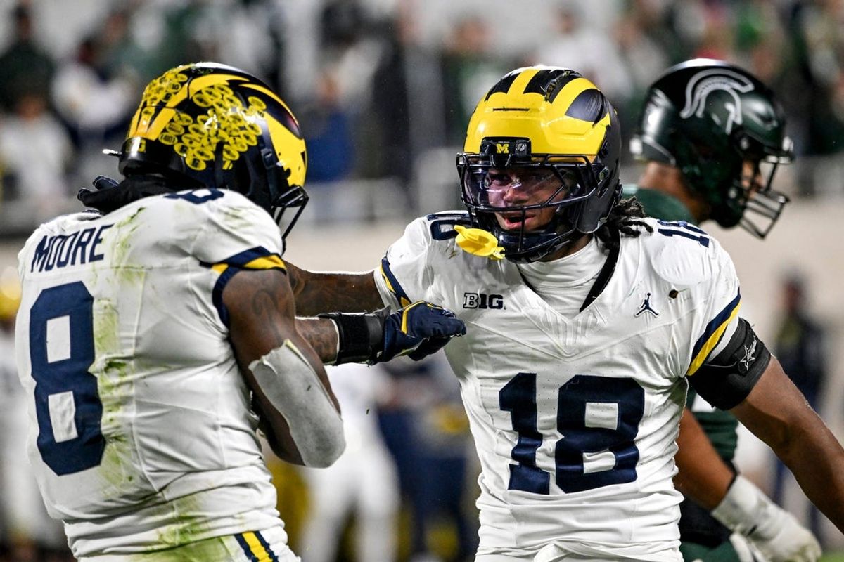 Michigan's Derrick Moore, left, celebrates a sack with Troy Bowles during the fourth quarter in the game against Michigan State on Saturday, Oct. 25, 2025, at Spartan Stadium in East Lansing.